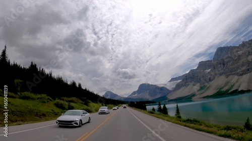 Scenic Road Trip Through Rocky Mountains with Lake View