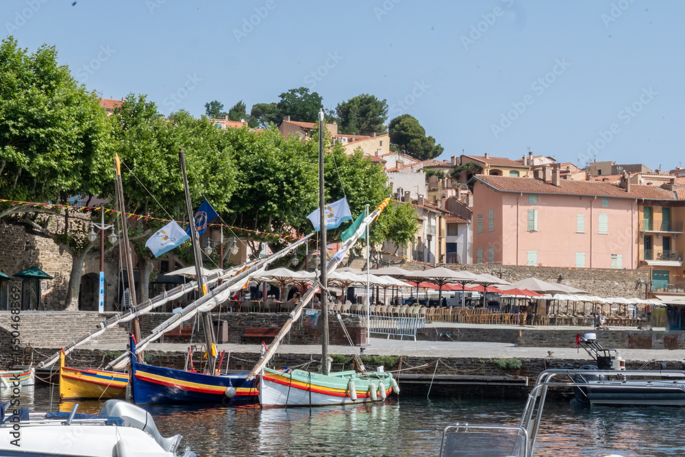 Fototapeta premium View of colourful Collioure, narrow streets and yellow, pink, orange houses, summer vacation destination town with historical buidings and beaches, Pyrenees-Orientales, France