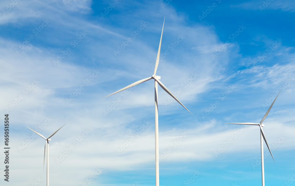 Fototapeta premium Wind mill power energy farm generator renewable sustainable field on blue sky, environment eco system technology industry ecology electricity power propeller turbine clean carbon.