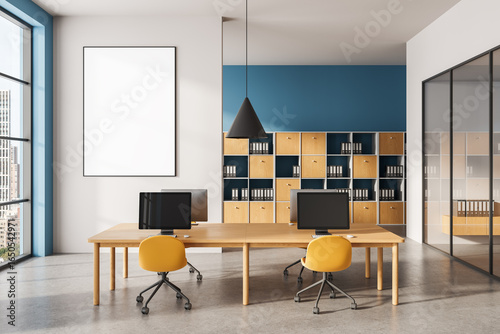 Photos Modern office interior with blank vertical poster mockup on wall, wooden desks and yellow chairs in contemporary workspace setting