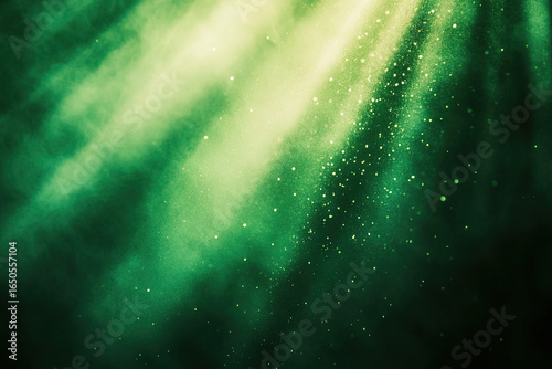 Abstract green background with glowing light beams and dust particles creating atmosphere