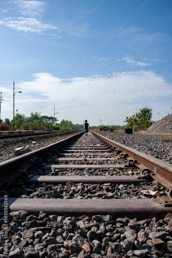 Fototapeta premium a boy walking on railway