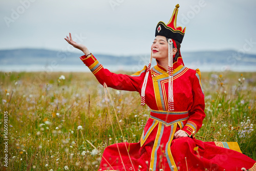 Mongolian girls dressed in luxurious Mongolian costumes on the grassland