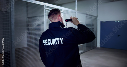 Bild auf Leinwand Night Security Officer Using Flashlight