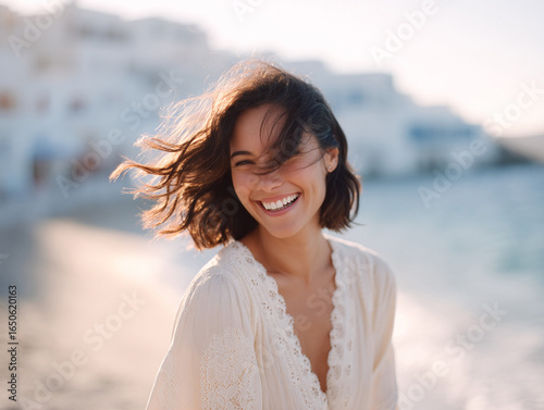 Radiant woman laughing freely at the beach. Evokes joy, natural beauty, and carefree travel. Ideal for lifestyle, wellness, or vacation ads.