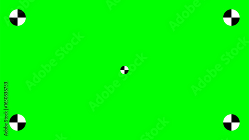 Bright green screen background with five black and white tracking markers, one in the center and four in the corners, used for chroma keying, motion tracking, and visual effects in video production.