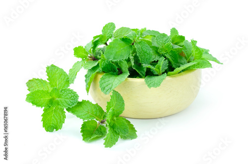 fresh herbs in a bowl, Heap of fresh raw mint or lemon balm, mint leaves, in wooden cup and outside isolated on white background 
 closed up stack
