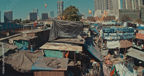Mumbai, India. Panoramic View On Dhobi Ghat And Modern Skyscrapers. Dhobi Ghat Is Open Air Laundry. Rich And Poor. One Of Largest Outdoor Laundry. Orange Flags Fluttering, Symbolizing Hanuman. Class