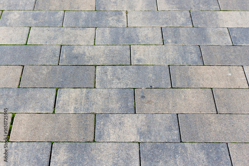 Grey brick wall background close up. Gray stone tile block background with horizontal texture of gray brick. Gray brick surface.