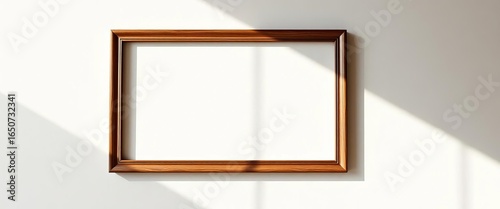 Empty picture frame on sunlit wall, dust motes visible,   wall decor,   wooden frame