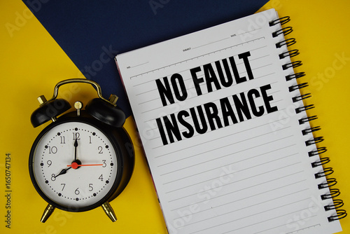 No Fault Insurance text written on notepad with alarm clock on yellow background