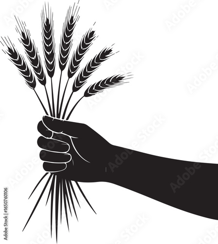 Hand holding wheat stalks, symbol of harvest and abundance