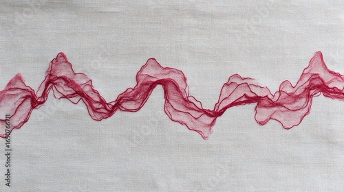 Delicate crimson threads flowing on light fabric