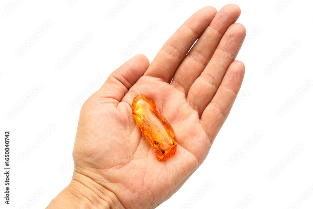 Amber on the palm. Sun stone. Fossil fossilized resin. semi-precious mineral. Natural material for jewelry. Copal. Science. Polished amber stone. Amber on the palm. Sun stone. Fossil fossilized resin. semi-precious mineral. Natural material for jewelry. Copal. Science. Polished amber stone.