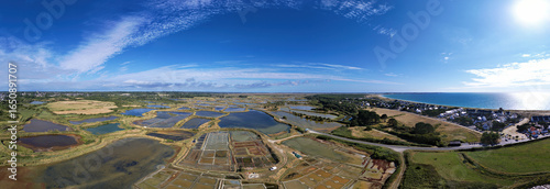 Panorama with sea salt marshes of Guerande, La Turballe with Pen Bron and Le Croisic with sea in the peninsula of Guerande, Brittany, France, drone photo