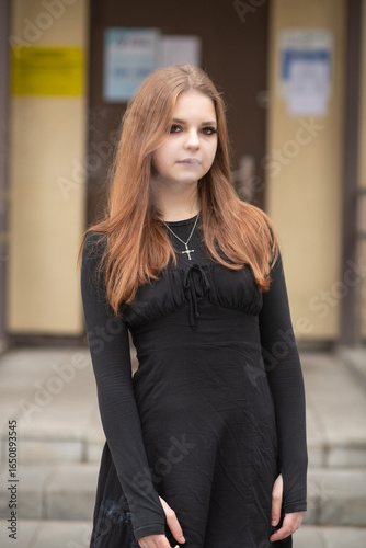 Free Download Portrait of a young beautiful red-haired girl in a black dress outdoors on an autumn day. - GFXLoad