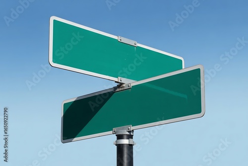 Vibrant green street signs against a crisp blue sky offer endless possibilities for wayfinding and creative design projects