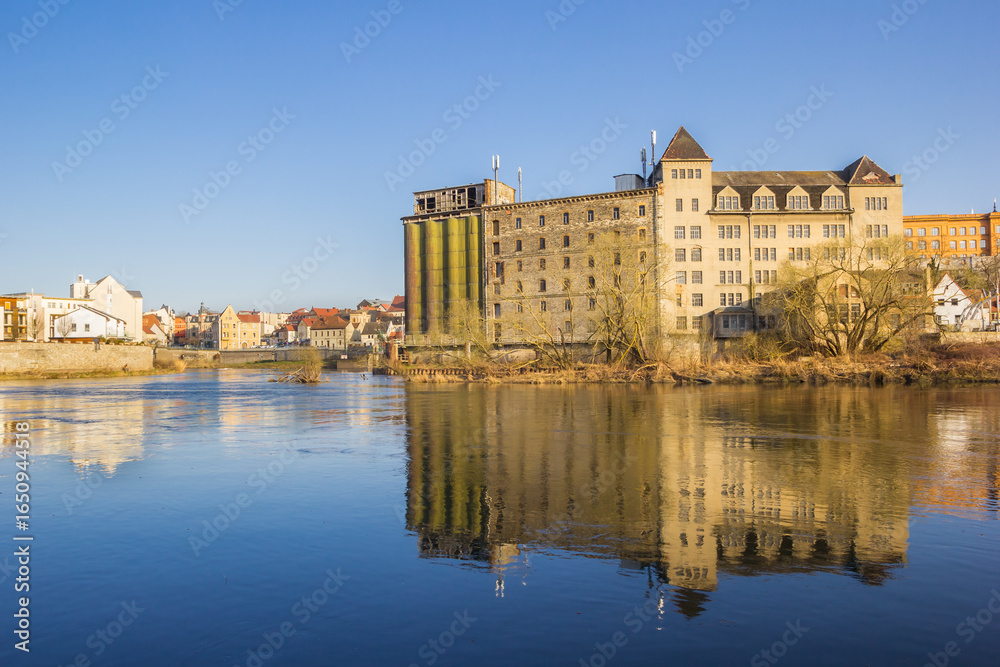 Naklejka premium Hydroelectric power station with reflection in the Saale river in Bernburg, Germany