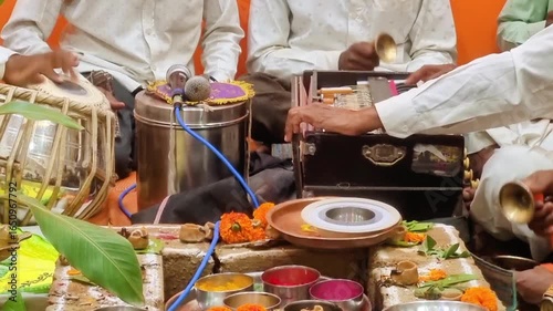 Hindu Puja: A worship ritual performed by Hindus for devotion, honoring guests, or celebrating events. Scene shows typical setup with essential elements and instruments like tabla and harmonium.