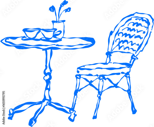 Table with teapot, cup, and chair