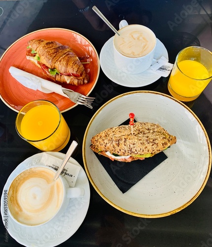 Delicious Breakfast With Sandwiches, Coffee, and Orange Juice on a Table