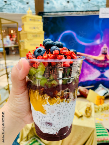 Colorful Layered Smoothie Featuring Chia Seeds, Fresh Berries, and Tropical Fruits