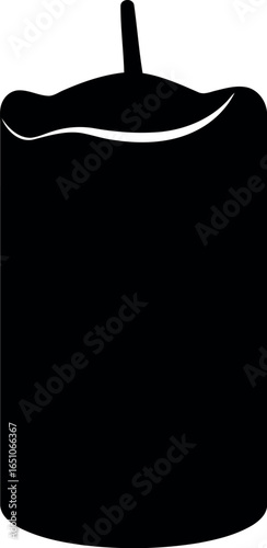 Black pillar candle with lit wick