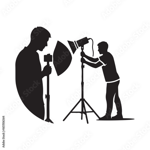 Silhouette of two photographers with studio lighting
