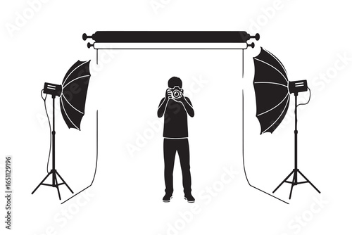 Silhouette of photographer with camera in studio setup