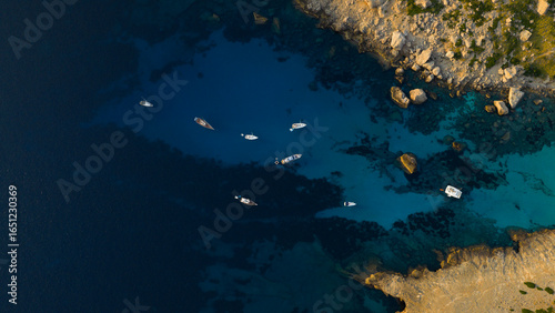 Aerial view of beautiful bay with turquoise water and longtail boats anchoring. Travel photo, Mallorca, Spain.