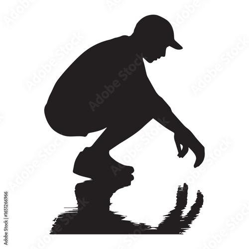 Silhouette of a person squatting reaching for something in water