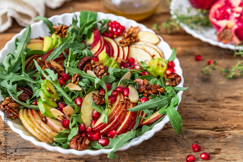 Autumn salad with apple, pomegranate, nuts and honey