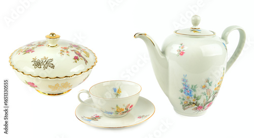 Fotografie Elegant vintage porcelain coffee pot, vintage sugar bowl, porcelain cup and saucers isolated on white