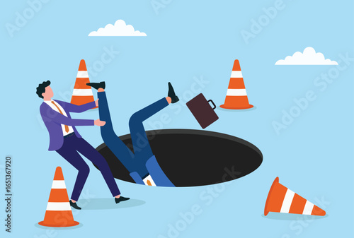 Vector illustration of one businessman falling into a dark hole while another tries to pull him out, representing teamwork, rescue, support, and helping colleagues in tough times
