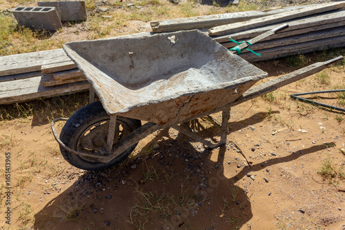 wheelbarrow with tools on the ground