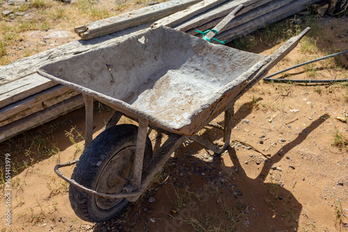 wheelbarrow with tools on the ground