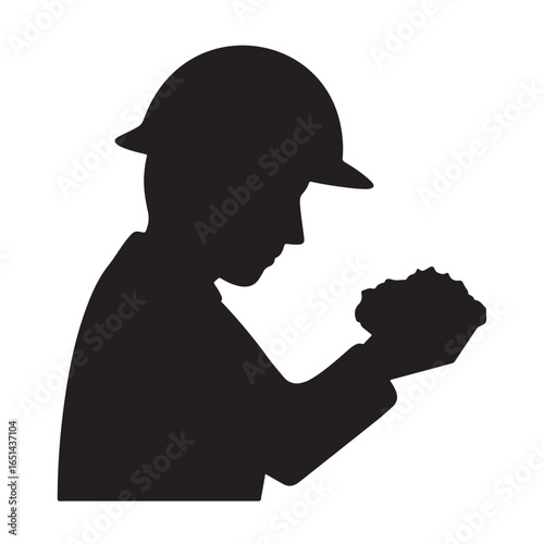 Silhouette of miner holding coal in hard hat and uniform mining worker