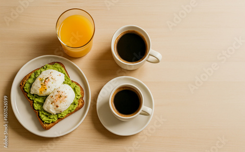 Healthy Breakfast with Avocado Toast, Poached Eggs, Coffee and Orange Juice