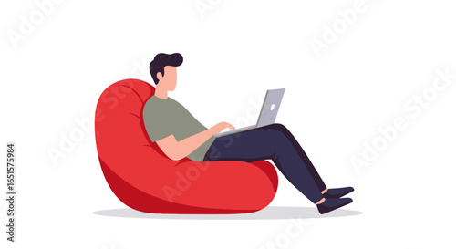 Young man in casual clothes working on a laptop, comfortably seated on a large red beanbag chair.