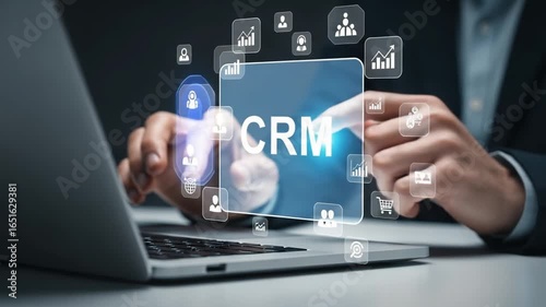 A person interacting with a crm interface on a laptop with various business icons around it