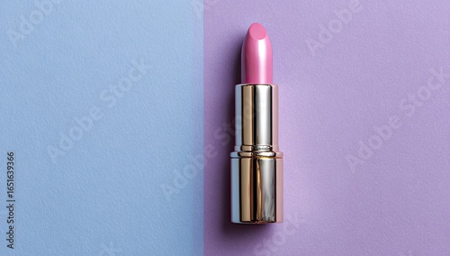 A single tube of light pink lipstick stands upright on a split pastel background of periwinkle and lilac