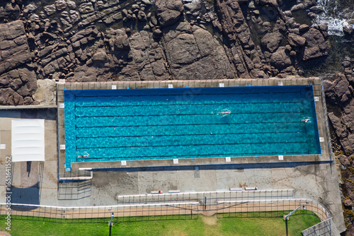 The beautifully scenic Shellharbour Ocean Pool located on the Illawarra coastline, NSW, Australia. It is one of many historic ocean pools along the South Coast. Captured from high above on sunrise.