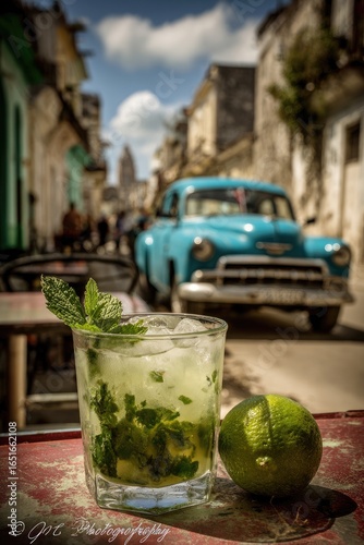Mojito cocktail on a street cafe table in Cuba, vintage car in background