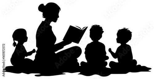 Silhouette of Teacher Reading Book to Young Children Sitting on Floor