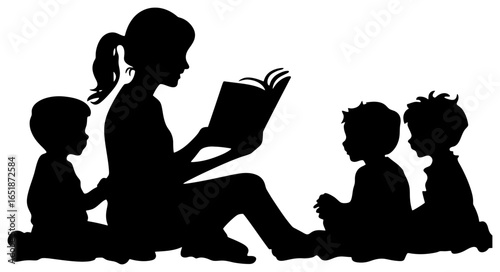 Silhouette of Teacher Reading Book to Young Children Sitting on Floor