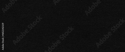 Fotografie The enigmatic black felt seamless texture cloaks in mystery.