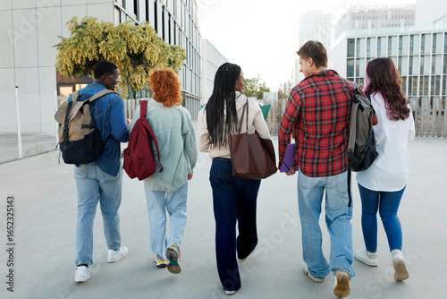 Diverse university or college students walking together on campus