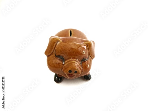 Brown piggy bank isolated in white background
