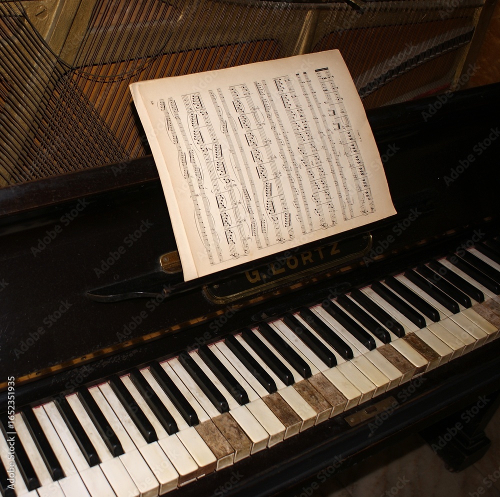 Fototapeta premium Sheet music placed on vintage upright G. Loritz piano keyboard