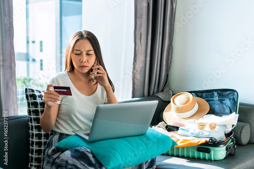 Asian traveler woman had a problem with her credit card so she called the operator